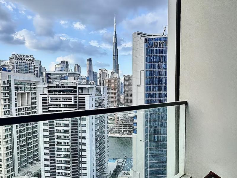 Balcony view of the Burj Khalifa and Dubai Canal in daylight